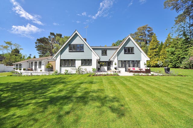 A home with a large front lawn.